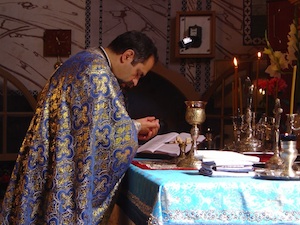 Priest
                taking communion